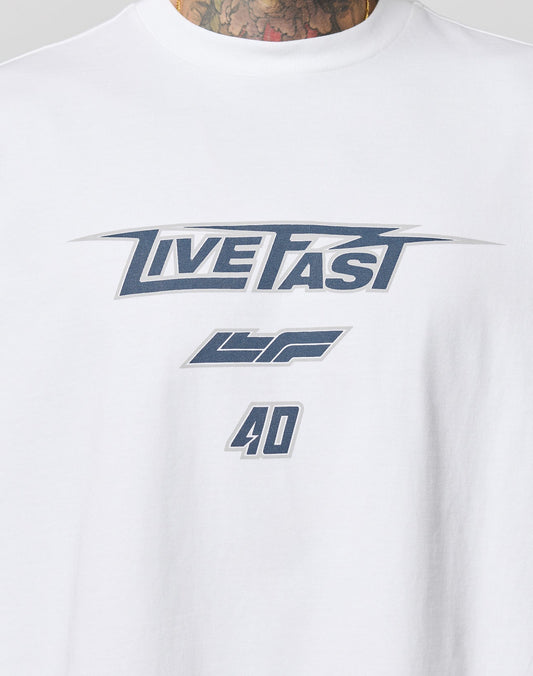 Close-up of the LFDY Triple Racing Tee by LIVE FAST DIE YOUNG: white 100% cotton with bold LIVE FAST text, LF and 40 in dark gray, multilogo details, Oversize Fit, and a tattooed neck for an edgy look.