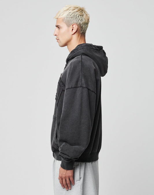 A young man with short, bleached blonde hair stands in profile wearing the LIVE FAST DIE YOUNG Ripped College Hooded Zip and light gray sweatpants against a plain light background.