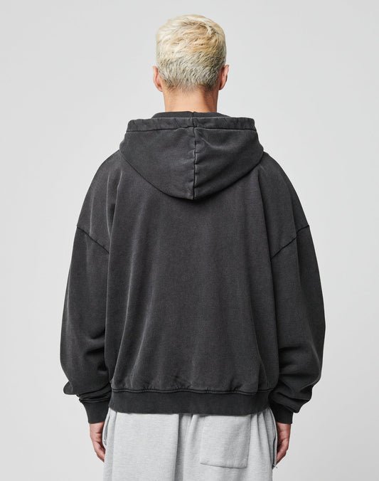 A person with short, bleached blonde hair is seen from behind wearing the LIVE FAST DIE YOUNG Ripped College Hooded Zip in Oversize Fit and light gray shorts. The 100% Baumwolle fabric contrasts with the plain, light-colored background.