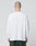 A person with a shaved head wears the LIVE FAST DIE YOUNG Basic Script Waffle Longsleeve, an oversize white 100% Baumwolle shirt, and green pants, standing with their back to a plain light gray background.