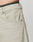 Close-up of a person wearing LFDY Baggy Denim jeans by LIVE FAST DIE YOUNG in light beige. Features include relaxed baggy fit, visible front pocket, black waistband detail, subtle fading, stitching accents, and a small Flag-Label. Made from Baumwolle.
