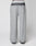 LIVE FAST DIE YOUNG’s Live Fast Boucle Pants feature a wide fit, straight leg, single front pocket, elastic waistband with text, and a gradient from dark to light gray at the waist and ankles. Displayed on a plain background.
