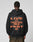 A person, facing away against a plain light background, wears an oversize fit black Print Over Hooded by LIVE FAST DIE YOUNG with bold orange LIVE ITS FUCK DIE YOUNG FOREVER FAST text on the back. Made from Baumwolle (cotton).