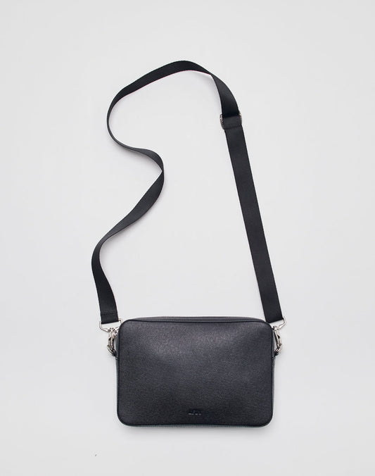 The Airliner Bag by LIVE FAST DIE YOUNG is a black rectangular crossbody in Rindsleder with an embossed logo, long adjustable strap, and silver hardware. Shown in one size on a plain white background.