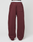The Basic Wide Jogger by LIVE FAST DIE YOUNG features a maroon wide fit, elastic waistband and cuffs, logo print, and a right-side patch pocket, shown against a plain white background.