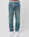A person wears LIVE FAST DIE YOUNG Regular Denim jeans in light blue, featuring a regular fit and tapered leg made from recycelte Baumwolle, paired with white sneakers. The photo shows the jeans from the waist down against a plain white background.