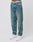 Wearing LIVE FAST DIE YOUNG Regular Denim blue jeans, made from recycled cotton with a regular fit and tapered leg, paired with white sneakers. Only the lower torso and legs appear against a plain white background.