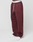 A person wears the LIVE FAST DIE YOUNG Basic Wide Jogger in maroon with side pockets, drawstrings, a white LIVE FAST waistband, and white sneakers, standing against a plain white background.