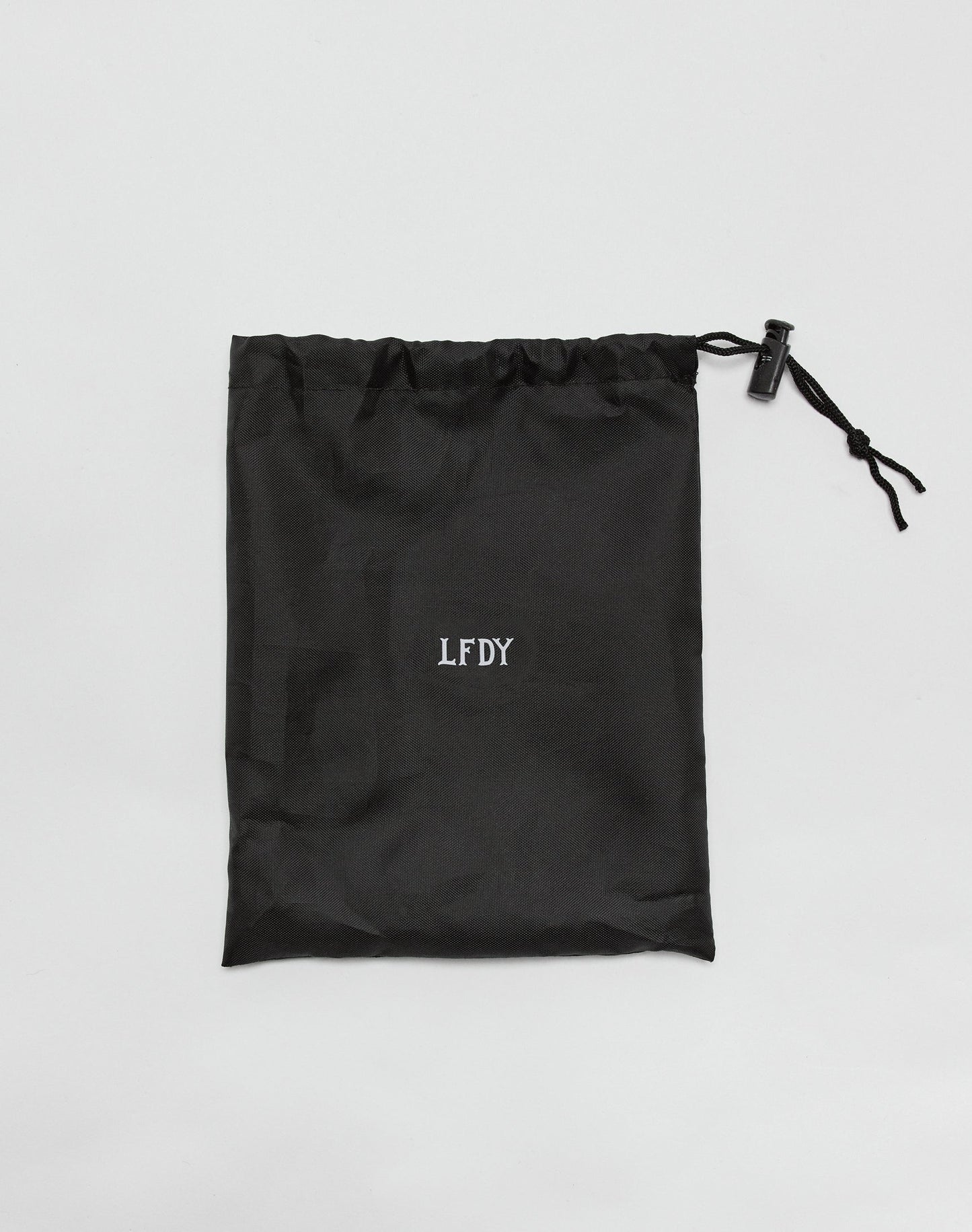 The LIVE FAST DIE YOUNG Live Fast Performance Jump Rope comes in a black drawstring bag with the brands logo in white on the center and length-adjustable metal handles, shown flat on a white background.