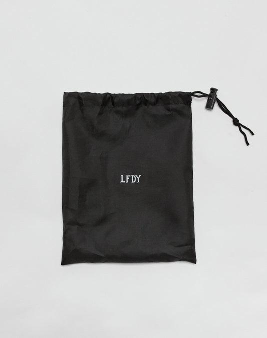 The LIVE FAST DIE YOUNG Live Fast Performance Jump Rope comes in a black drawstring bag with the brands logo in white on the center and length-adjustable metal handles, shown flat on a white background.