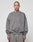 A person with a shaved head wears the LIVE FAST DIE YOUNG Basic Chest Sweater in an oversized, faded gray fit, paired with matching sweatpants and a subtle front print, standing facing forward against a plain light gray background.