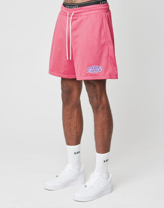 A person wears LFDY Oval Mesh Shorts by LIVE FAST DIE YOUNG with an elastic waistband and regular fit, plus white crew socks—both featuring LIVE FAST text—and white Nike sneakers, standing against a plain white background.