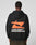 A person in a black LFDY Hardwear Hooded by LIVE FAST DIE YOUNG, made from Baumwolle with an orange abstract graphic and LIVE FAST HARDWEAR on the back, stands against a plain light gray background.