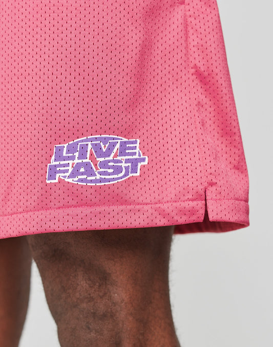 Close-up of a leg wearing LFDY Oval Mesh Shorts by LIVE FAST DIE YOUNG, featuring a purple and white LIVE FAST logo near the hem. These regular fit shorts have an elastischer Bund and are made from lightweight polyester.