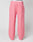 The Live Fast Boucle Pants by LIVE FAST DIE YOUNG are wide fit, pink fleece pants featuring an Elastikbund, side pockets, a straight leg cut, and a small front right patch pocket, shown on a mannequin against a plain background.