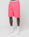 A person in bright pink LIVE FAST DIE YOUNG Basic Shorts with elastic waistband, white "LIVE EAST" socks, and white sneakers stands against a plain light background. The upper body is not visible.