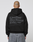 A person with a tattoo on the back of their head wears a LIVE FAST DIE YOUNG Basic 510 Hooded Zip in Oversize Fit with large gray front and back print, paired with gray jeans, facing away from the camera.