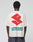 A person faces away, wearing the LFDY Dealership Tee by LIVE FAST DIE YOUNG—an oversize white 100% Baumwolle shirt with a bold red abstract backprint and "LIVEFAST DEALERSHIP" in striking teal letters.