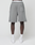A person faces forward wearing LIVE FAST DIE YOUNG Basic Shorts in gray with a large square pocket on the right leg, paired with white socks and sneakers against a plain white background.