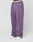 A person wears LIVE FAST DIE YOUNG Basic Wide Joggers in loose purple with a white drawstring and "LIVE FAST" elastic waistband, paired with white sneakers against a plain white background.