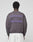 A person faces away, wearing the LFDY Network Sweater by LIVE FAST DIE YOUNG—an oversize dark gray cotton sweatshirt with purple "LIVEFAST DEALERSHIP" front and back prints—paired with white pants, set against a plain light background.