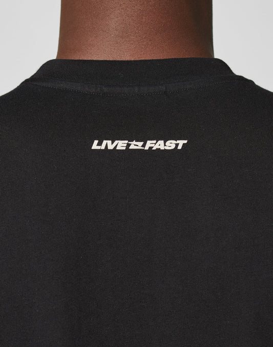 Close-up of the back of the black LFDY Mystic Tee by LIVE FAST DIE YOUNG in Oversize Fit, 100% Baumwolle, with a white LIVE FAST front and back print and a small airplane icon between the words below the collar.