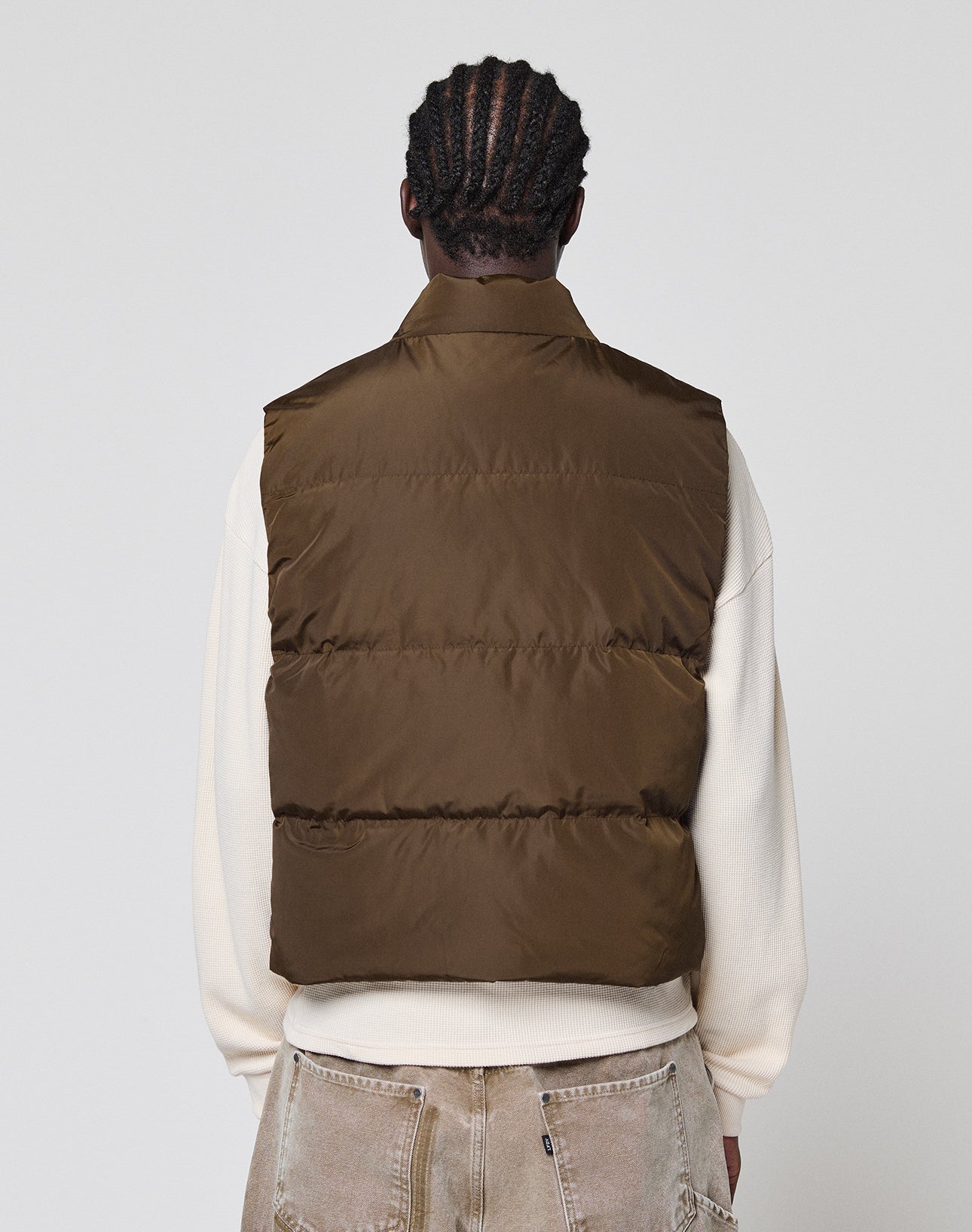 A man wearing the Live Fast Cropped Vest by LIVE FAST DIE YOUNG.