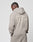 A person with braided hair, seen from the side and back, wears a beige LIVE FAST DIE YOUNG Basic 510 Hooded Zip in an oversize fit. LiveFast Hvy Sweat 510g/m² is printed large on the back against a plain white background.