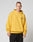 Wearing the Print Over Hooded by LIVE FAST DIE YOUNG, a person in an oversize yellow hoodie with black chest text and a front pocket stands against a light gray background. The hoodie is made from 100% Baumwolle for comfort.