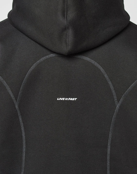The back of the black LFDY Active Fleece Hooded Zip by LIVE FAST DIE YOUNG features an oversize fit, curved seams, a subtle logo, and LIVE FAST in small white letters at the center.
