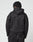 A person with short, twisted hair wears an Oversize Fit black LIVE FAST DIE YOUNG LFDY Active Fleece Hooded Zip and matching pants, facing away from the camera against a white background. The hoodie has subtle white stitching and a small back logo print.
