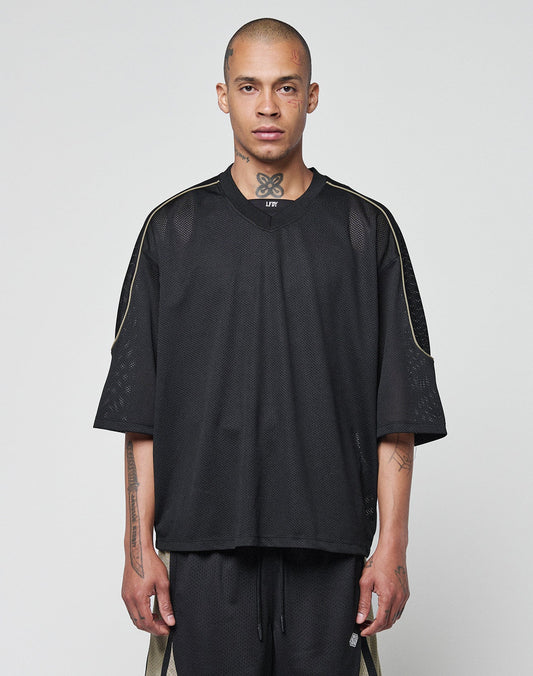 A person with closely shaved hair wears a LIVE FAST DIE YOUNG Basic Mesh Jersey and matching shorts with contrast piping, standing against a light gray background, facing forward with a neutral expression. | model