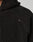 Close-up of a black, textured fleece Live Fast Teddy Jacket by LIVE FAST DIE YOUNG in oversize fit, featuring visible seam details and a small fabric tag reading LEBON sewn onto the chest area.