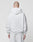 A person with a shaved head is seen from behind wearing the LIVE FAST DIE YOUNG Basic Script Hooded Zip in light gray cotton-polyester against a plain light background.