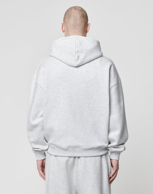 A person with a shaved head is seen from behind wearing the LIVE FAST DIE YOUNG Basic Script Hooded Zip in light gray cotton-polyester against a plain light background.