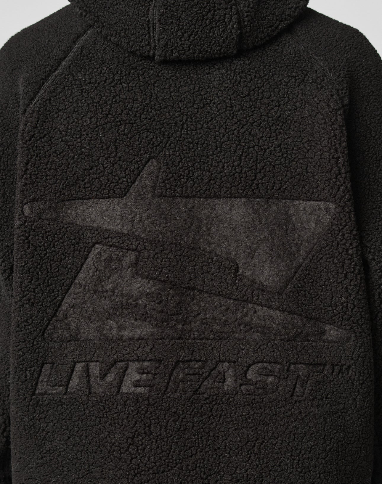 Back of the black Live Fast Teddy Jacket by LIVE FAST DIE YOUNG in Oversize Fit, featuring an embossed large stylized lightning bolt and “LIVE FAST™” below it.