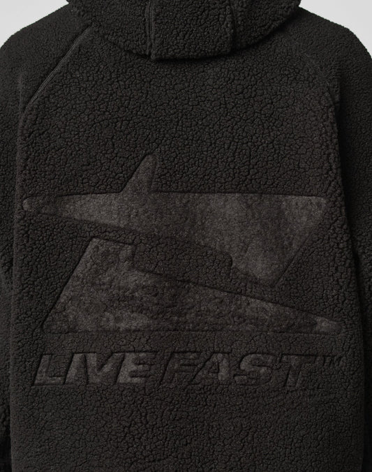 Back of the black Live Fast Teddy Jacket by LIVE FAST DIE YOUNG in Oversize Fit, featuring an embossed large stylized lightning bolt and “LIVE FAST™” below it.
