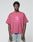 A person wears the Live Fast LF Tee by LIVE FAST DIE YOUNG—an oversize pink T-shirt with a bold "LIVEFAST" frontprint and stylized logo, made from 100% Baumwolle—paired with light blue jeans against a plain background.