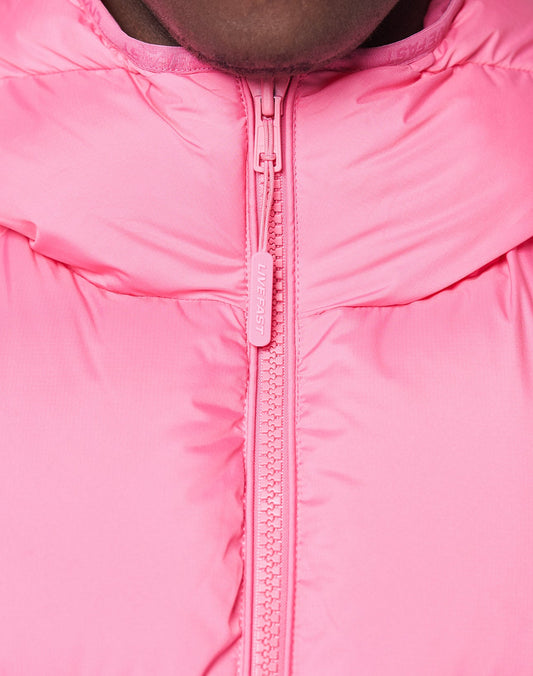 Close-up of a person in the Live Fast Puffer Jacket by LIVE FAST DIE YOUNG, featuring a bright pink oversize fit, high padded collar, visible zipper with LIVE FAST on the pull, and a subtle reflective print for added style.