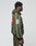 A person in profile wears an oversize fit olive LFDY Nylon Trackjacket by LIVE FAST DIE YOUNG, with Kapuze mit Elastik-Tunnelzug, matching pants, a bold white 8 on the sleeve, Front- und Backprint, and red/white patches. Plain light gray background.