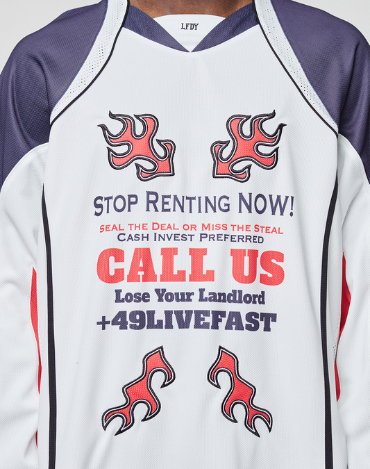 A person wearing the LFDY Call Us Jersey by LIVE FAST DIE YOUNG: an oversized white and purple polyester jersey with red flames and bold "STOP RENTING NOW! CALL US Lose Your Landlord +49LIVEFAST" text, plus other promo phrases.