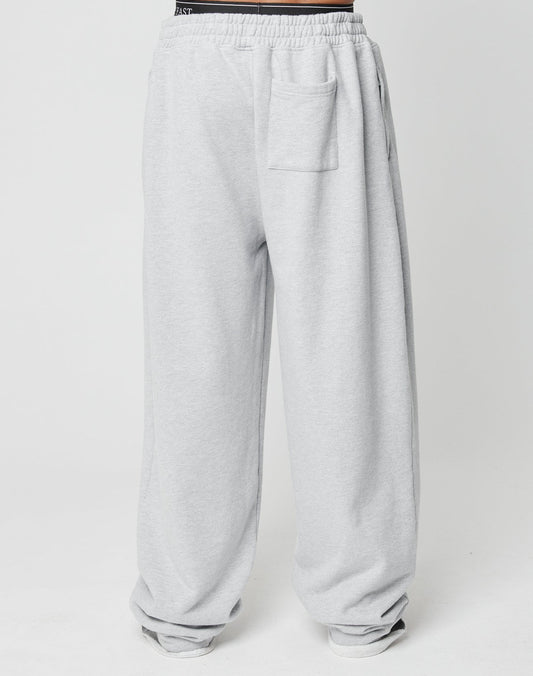 The Loyal Wide Jogger by LIVE FAST DIE YOUNG features an oversize fit, elastic waistband, side pockets, and a patch pocket on the front right thigh in light gray, displayed on a plain white background.