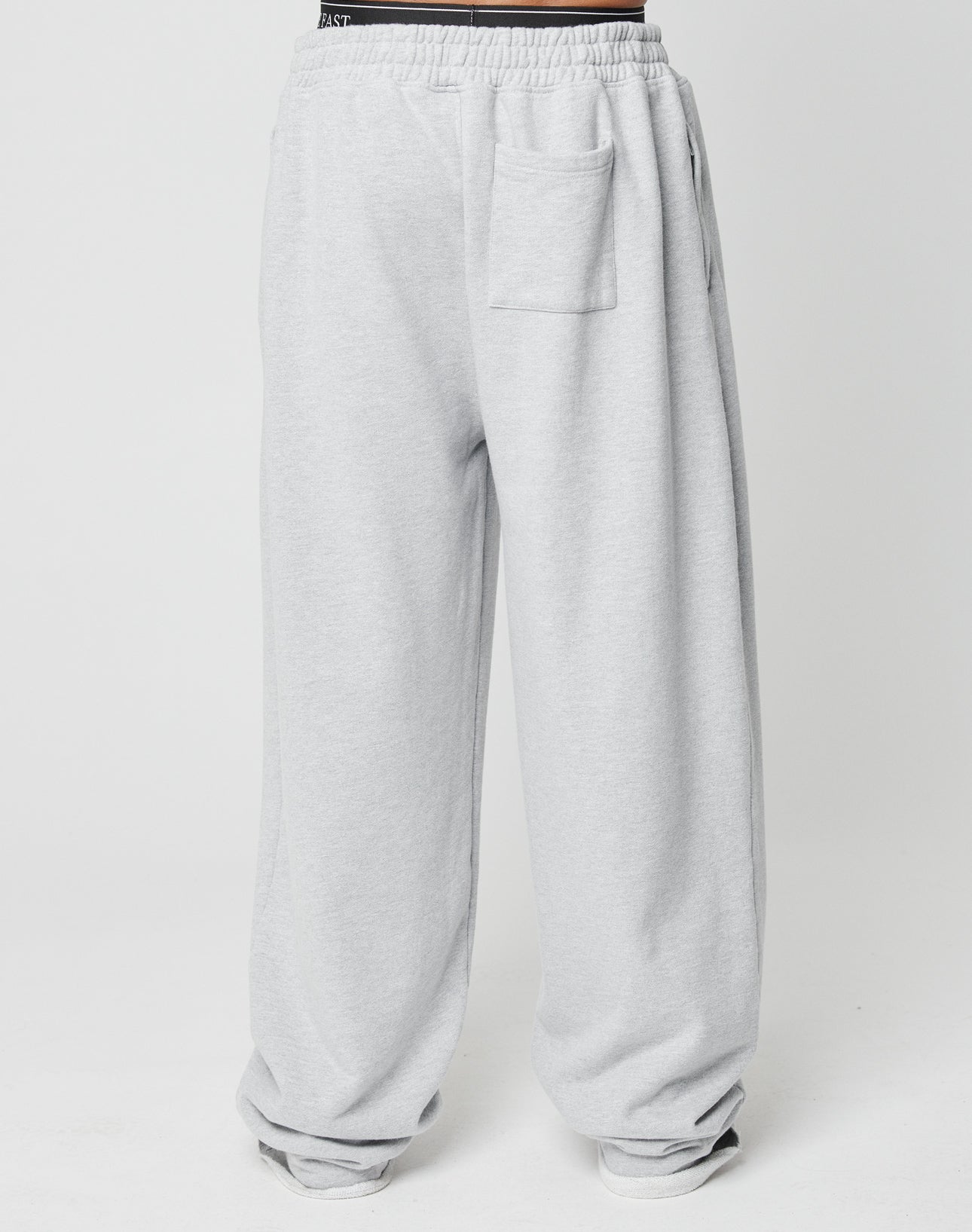 The Loyal Wide Jogger by LIVE FAST DIE YOUNG features an oversize fit, elastic waistband, side pockets, and a patch pocket on the front right thigh in light gray, displayed on a plain white background.