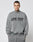 A man with short hair and neck tattoos models the LIVE FAST DIE YOUNG Live Fast Europe Run Sweater, a gray oversized sweatshirt with a bold front print, against a plain light background.