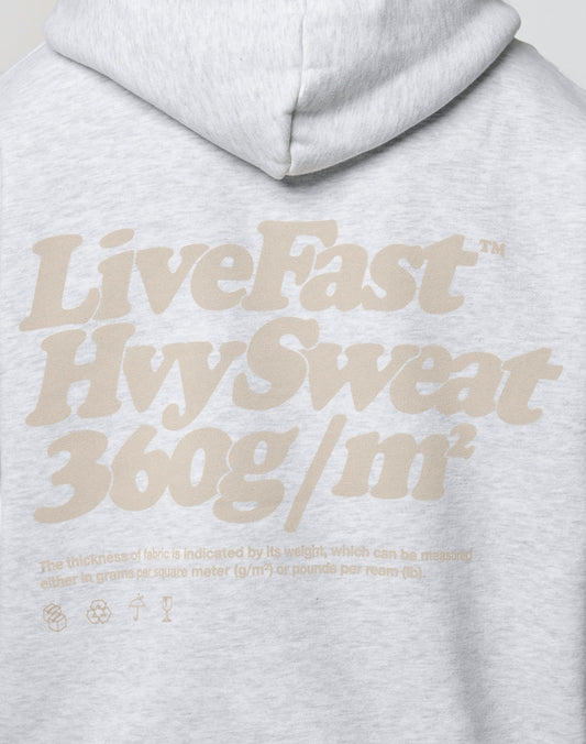 The Basic 360 Hooded by LIVE FAST DIE YOUNG is a light gray oversized hoodie with bold beige LiveFast Hvy Sweat 360g/m² text and smaller notes on its Baumwolle-Polyester fabric weight plus laundry care icons on the back.