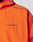 Close-up of the Live Fast Trackjacket by LIVE FAST DIE YOUNG, featuring bright orange Nylon-Elastan fabric with black piping and LIVE FAST printed in black on the chest. Only the upper torso and part of the shoulder are shown.