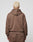 Seen from behind, a person with short, bleached blonde hair wears the LFDY Lightweight Hooded Zip by LIVE FAST DIE YOUNG and matching brown Regular Fit pants, standing against a plain light gray background.