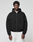 A person stands facing forward, wearing a LIVE FAST DIE YOUNG LFDY Grand Theft Hooded Zip in black and white pants, against a plain light gray background.