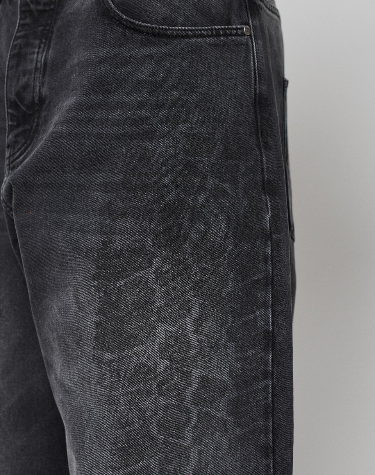 Close-up of the LFDY Tire Tracks Denim by LIVE FAST DIE YOUNG, featuring a baggy fit and a faded, textured pattern resembling tire tracks on the thigh near the front pocket for added comfort and style.