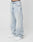 Person trägt die LFDY Baggy Denim von LIVE FAST DIE YOUNG aus 100% Baumwolle in Light-Wash-Optik mit Faded-Effekt und weitem, geradem Bein zu weißen Sneakern vor weißem Hintergrund. High-Waist-Schnitt, lockere Passform. Oberkörper nicht sichtbar.